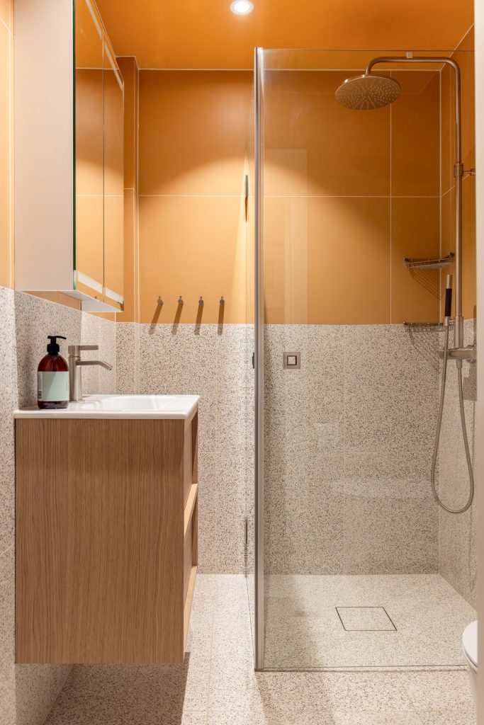 Et moderne bad med et retro og lekent uttrykk. Gulfargen og terrazzoflisene gir badet et unikt preg. Badet er totalrenovert av Lomundal.