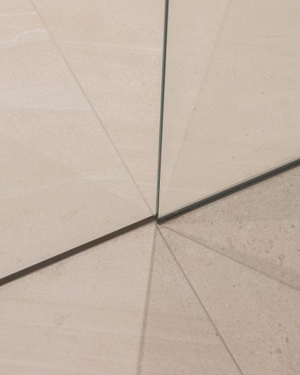Detaljbilde av gulvfliser på baderom i skandinavisk stil. Store, nøytrale fliser er et tidløst valg. Utført av Lomundal.