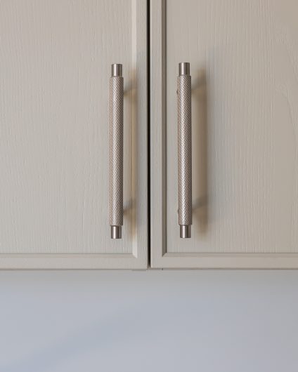 Et lyst, klassisk kjøkken i malt askefiner med smale rammer fra Svane Kjøkkenet. Utført av Lomundal.