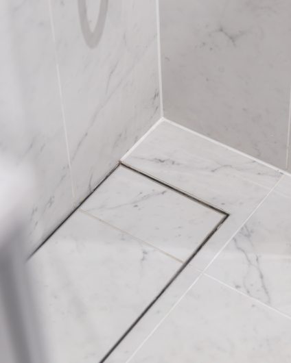 Moderne dusjsone med Carrara marmor på gulv og vegger. Utført av Lomundal.