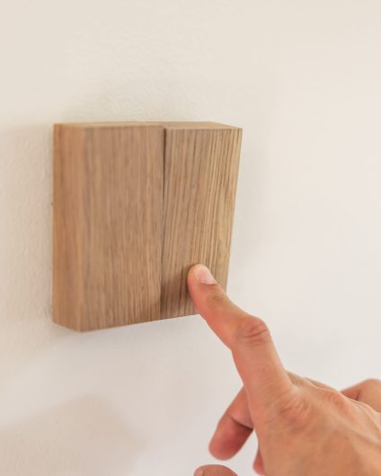 Detaljbilde av deksel til lysbryter i eik. Totalrenoveringen er utført av Lomundal.